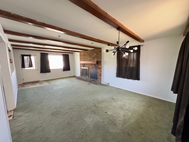 unfurnished living room with beamed ceiling, carpet floors, a fireplace, and a notable chandelier