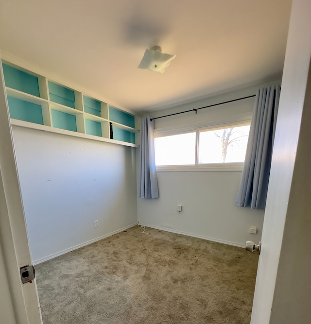 carpeted spare room with baseboards