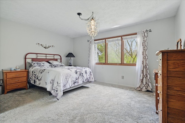 bedroom featuring baseboards, carpet flooring, a chandelier, and a textured ceiling