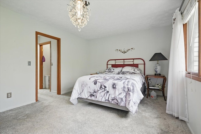 bedroom featuring baseboards, carpet flooring, and a chandelier