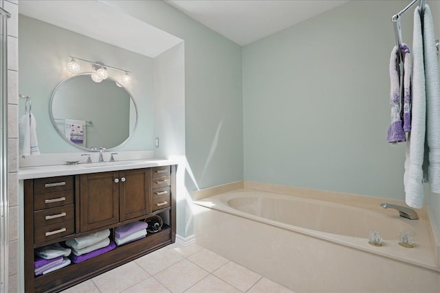 bathroom featuring a bath, baseboards, tile patterned flooring, and vanity