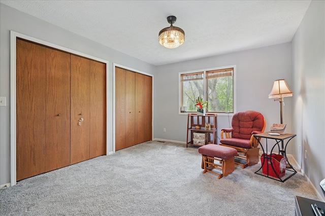 living area with carpet flooring and baseboards