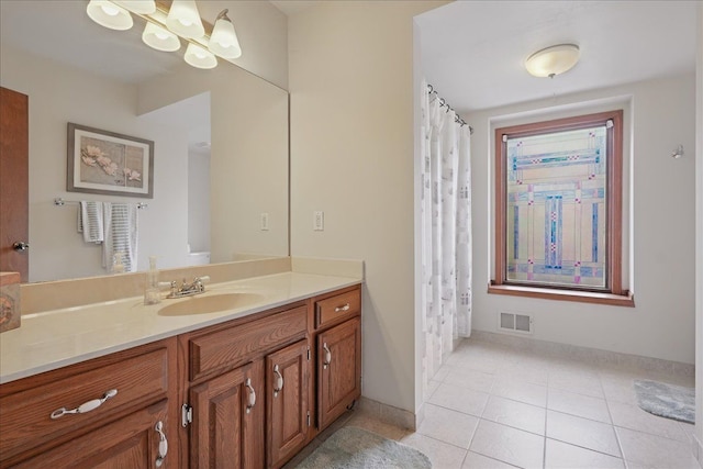 full bath with vanity, visible vents, tile patterned floors, a chandelier, and baseboards