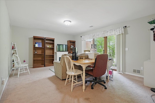 dining room featuring light colored carpet, visible vents, and baseboards