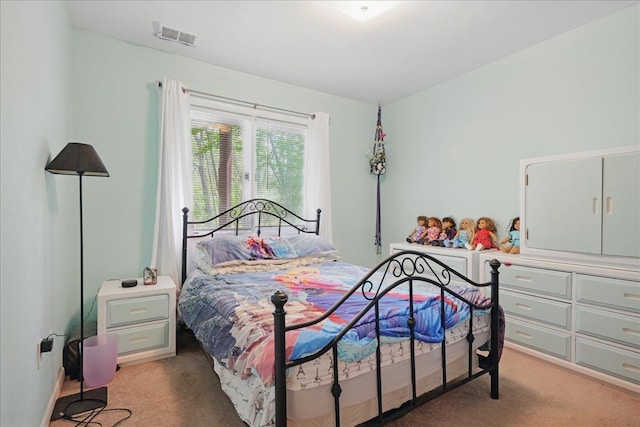 bedroom featuring light colored carpet and visible vents