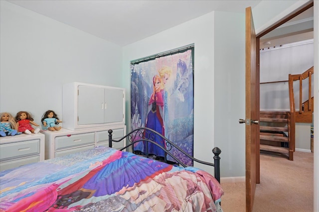 bedroom featuring light colored carpet and baseboards