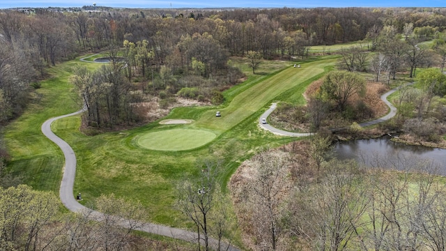 birds eye view of property with a water view and view of golf course