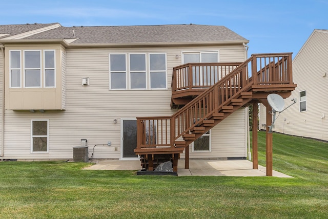 rear view of house with stairs, a patio area, a wooden deck, and a lawn