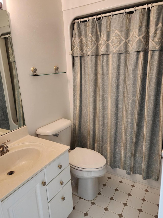 full bath with vanity, tile patterned floors, toilet, and a shower with curtain
