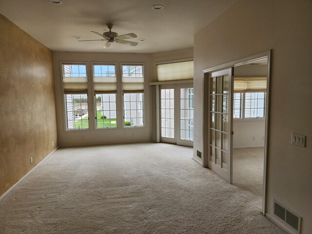 2411 Lake Ave Unit 20, Muskegon, MI 49445 - carpeted empty room with a wealth of natural light, visible vents, baseboards, and a ceiling fan