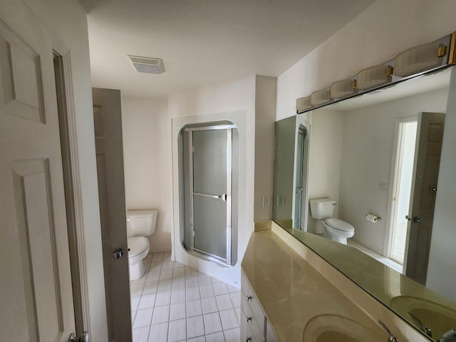 2411 Lake Ave Unit 20, Muskegon, MI 49445 - bathroom featuring toilet, a stall shower, visible vents, tile patterned flooring, and vanity