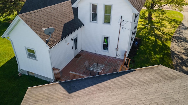 rear view of house with a shingled roof