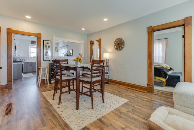 dining area featuring visible vents, recessed lighting, baseboards, and wood finished floors