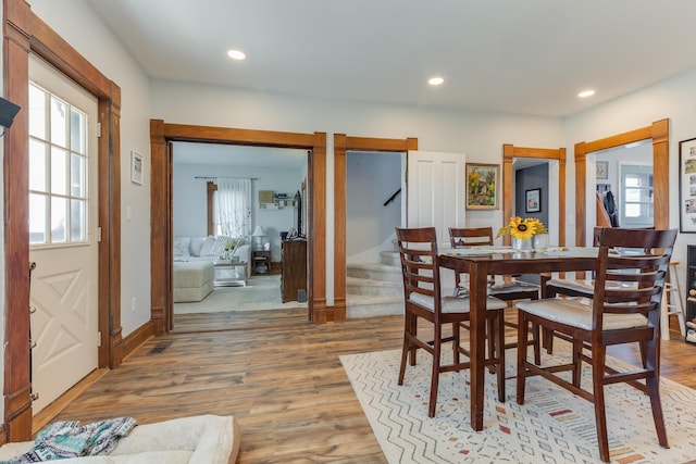 dining area featuring visible vents, recessed lighting, stairs, and light wood finished floors