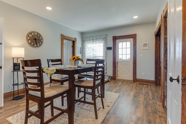 dining space featuring recessed lighting, baseboards, and wood finished floors