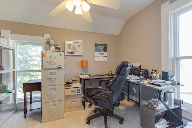 office space featuring ceiling fan, vaulted ceiling, and light colored carpet