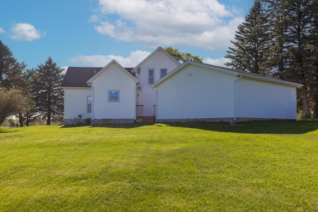 rear view of property featuring a yard