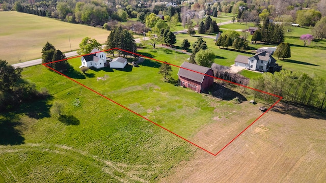 birds eye view of property with a rural view