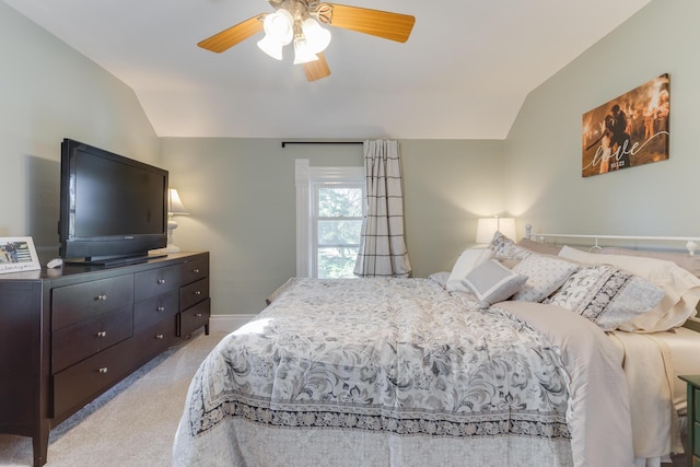 bedroom with light colored carpet, a ceiling fan, baseboards, and vaulted ceiling
