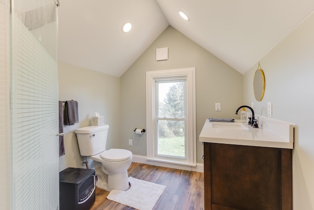 full bathroom with vanity, toilet, baseboards, wood finished floors, and vaulted ceiling
