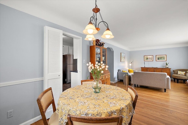 dining room with light wood-type flooring and baseboards