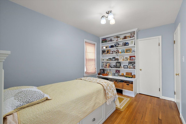 bedroom featuring light wood-style floors and baseboards