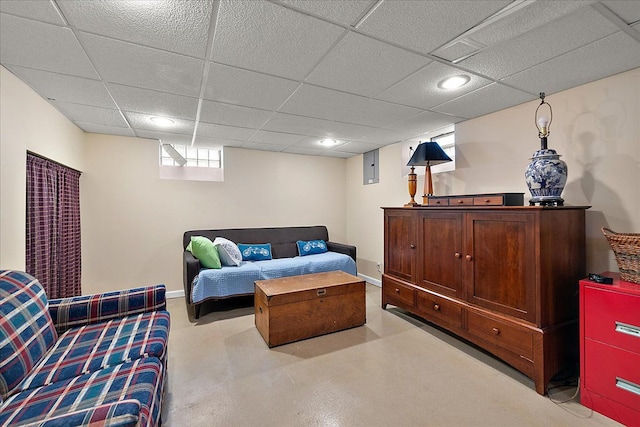 bedroom with finished concrete flooring and a paneled ceiling
