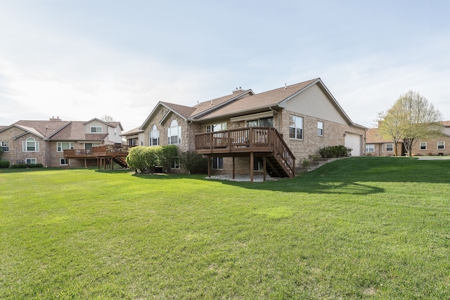 rear view of property with a wooden deck, a garage, brick siding, a yard, and stairs