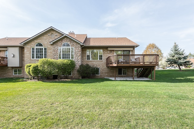 rear view of property featuring a wooden deck, a chimney, brick siding, a yard, and stairway