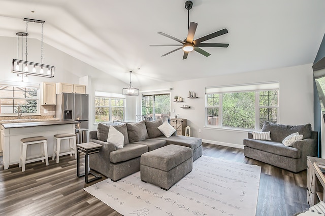 living room with dark wood-style flooring, a ceiling fan, plenty of natural light, and lofted ceiling