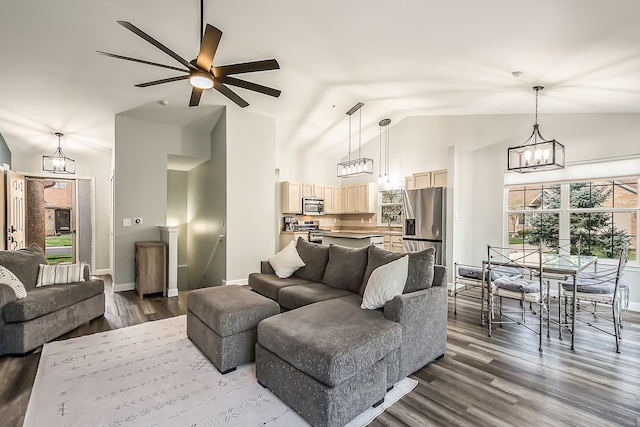 living area featuring high vaulted ceiling, baseboards, ceiling fan with notable chandelier, and dark wood-style floors