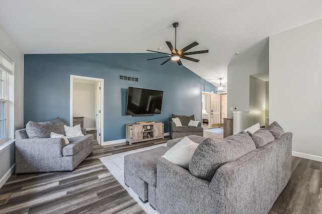 living area featuring a ceiling fan, lofted ceiling, dark wood-style floors, and visible vents