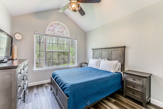 bedroom featuring baseboards, a ceiling fan, dark wood-style floors, and lofted ceiling
