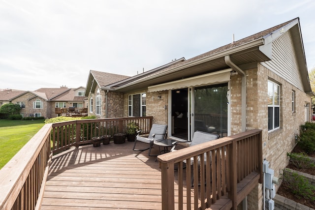 wooden deck featuring a yard