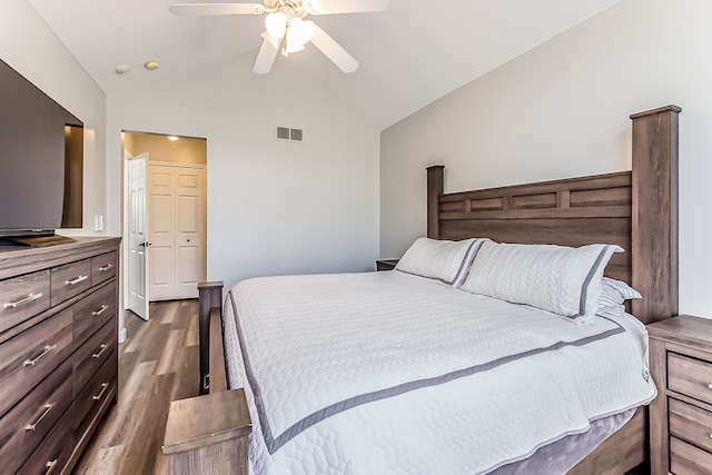 bedroom featuring a ceiling fan, high vaulted ceiling, visible vents, and wood finished floors