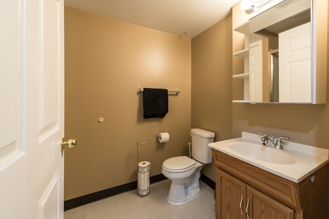 bathroom with baseboards, tile patterned floors, vanity, and toilet