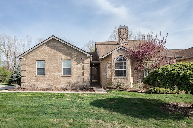 ranch-style house featuring brick siding, a front lawn, and a chimney