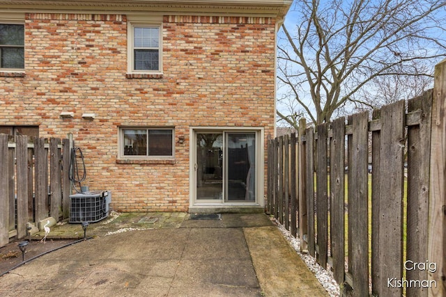 2464 Abbington Dr SE, Grand Rapids, MI 49506 - back of property featuring brick siding, a fenced backyard, and central AC