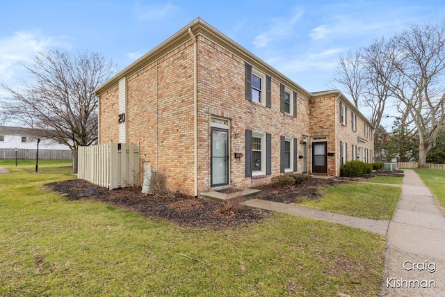 2464 Abbington Dr SE, Grand Rapids, MI 49506 - exterior space featuring brick siding, fence, and a yard