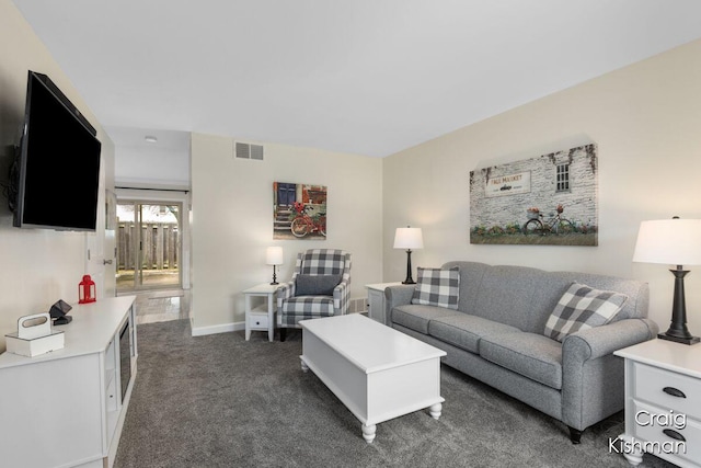 2464 Abbington Dr SE, Grand Rapids, MI 49506 - living room featuring baseboards, visible vents, and dark colored carpet