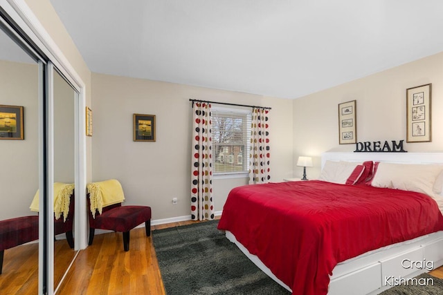 2464 Abbington Dr SE, Grand Rapids, MI 49506 - bedroom with a closet, baseboards, and wood finished floors