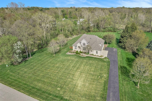 drone / aerial view featuring a forest view