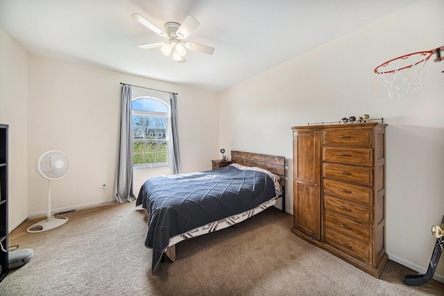 carpeted bedroom with ceiling fan and baseboards
