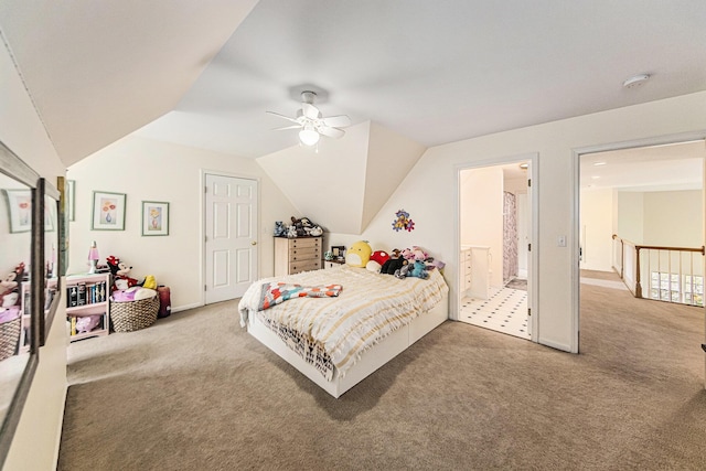 bedroom featuring carpet floors, a ceiling fan, ensuite bathroom, and vaulted ceiling