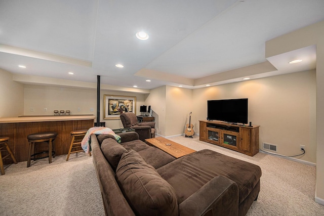 living room featuring visible vents, recessed lighting, bar area, and light carpet