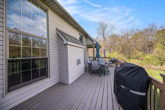 wooden deck featuring area for grilling and outdoor dining area
