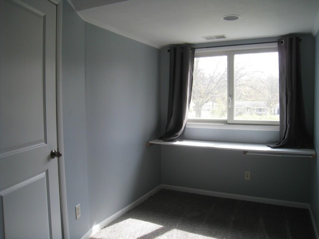 carpeted empty room featuring visible vents and baseboards