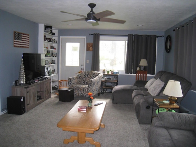 carpeted living room with a ceiling fan