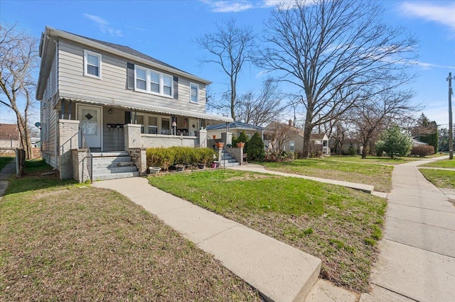 view of front of house with covered porch and a front yard