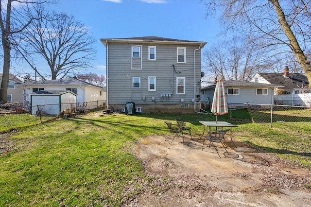 rear view of property featuring a lawn, a fenced backyard, and a patio area